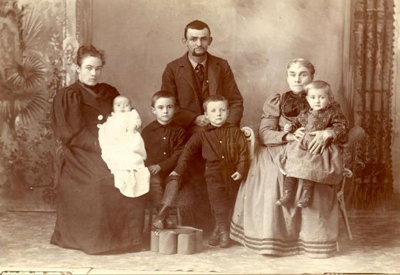 Victoria Frost Holcombe holding James
Wade Archie Holcombe in front with his hand on John Arthur's knee
Charles Dickens Holcombe in the back
Mariannne Ward Paxton Holcombe on the right holding Sidney Hugh Holcombe